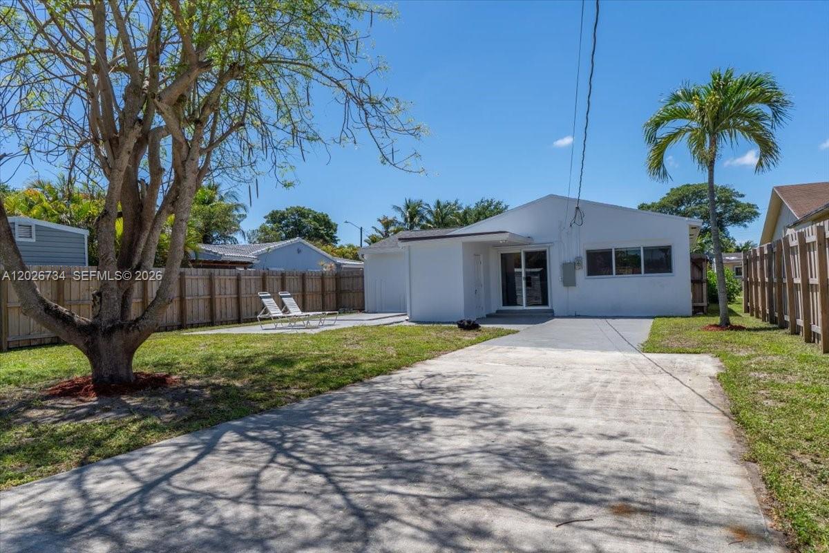 266 Southwest 6th Street Dania Beach, FL 33004 - Photo 32 of 37 a front view of a house with garden and plants