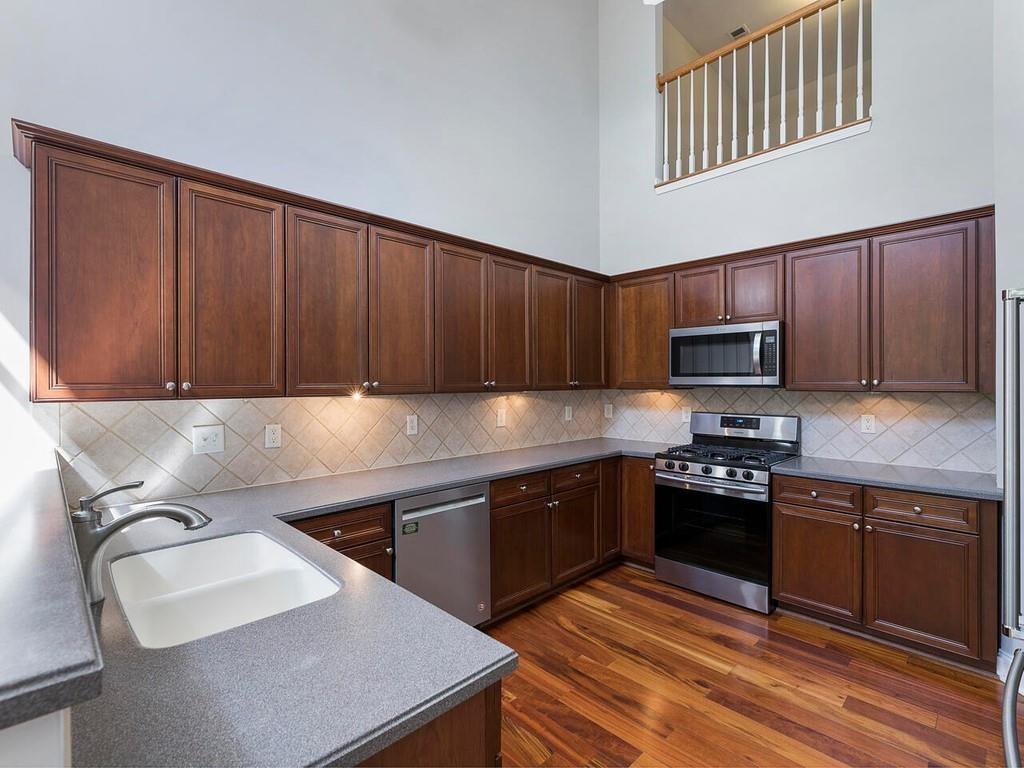 820 Freedom Lane Roswell, GA 30075 - Photo 11 of 30 a kitchen with stainless steel appliances granite countertop a sink stove refrigerator and cabinets