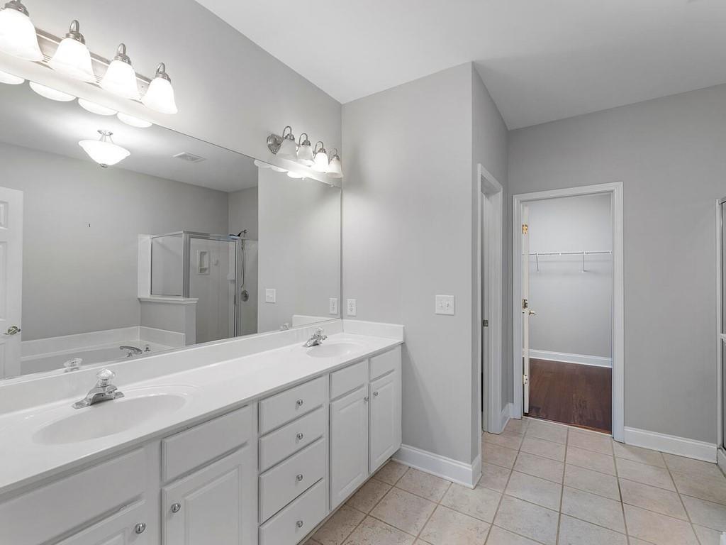 820 Freedom Lane Roswell, GA 30075 - Photo 20 of 30 a spacious bathroom with a double vanity sink a large mirror and a shower