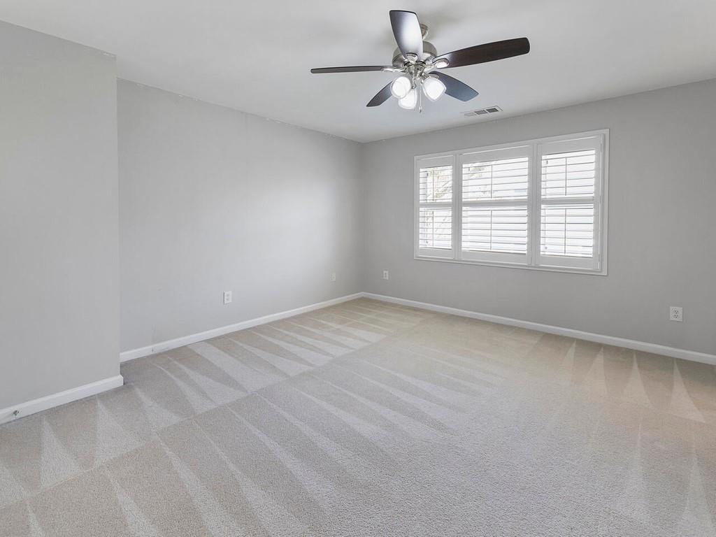 820 Freedom Lane Roswell, GA 30075 - Photo 24 of 30 an empty room with a window and a fan