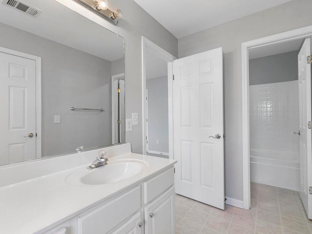 820 Freedom Lane Roswell, GA 30075 - Photo 27 of 30 a bathroom with a sink and a mirror