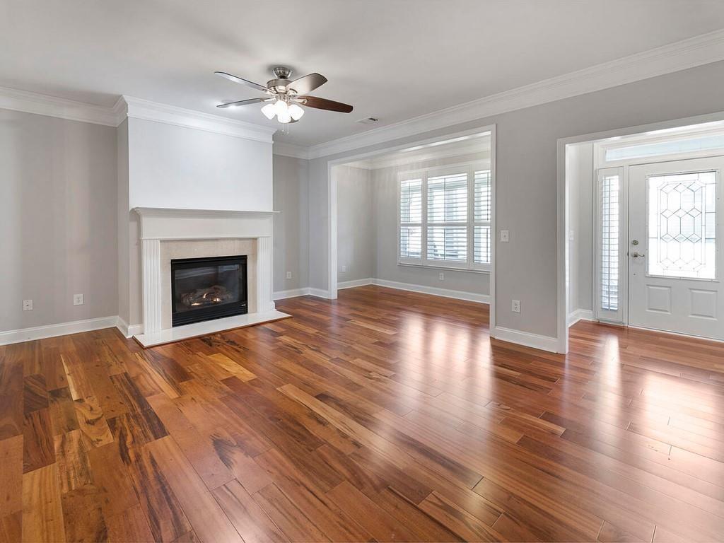 820 Freedom Lane Roswell, GA 30075 - Photo 6 of 30 a view of an empty room with wooden floor fireplace and a window