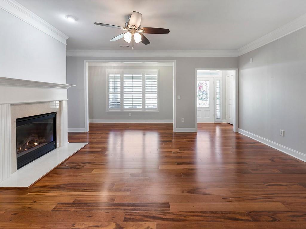 820 Freedom Lane Roswell, GA 30075 - Photo 7 of 30 a view of an empty room with wooden floor fireplace and a window