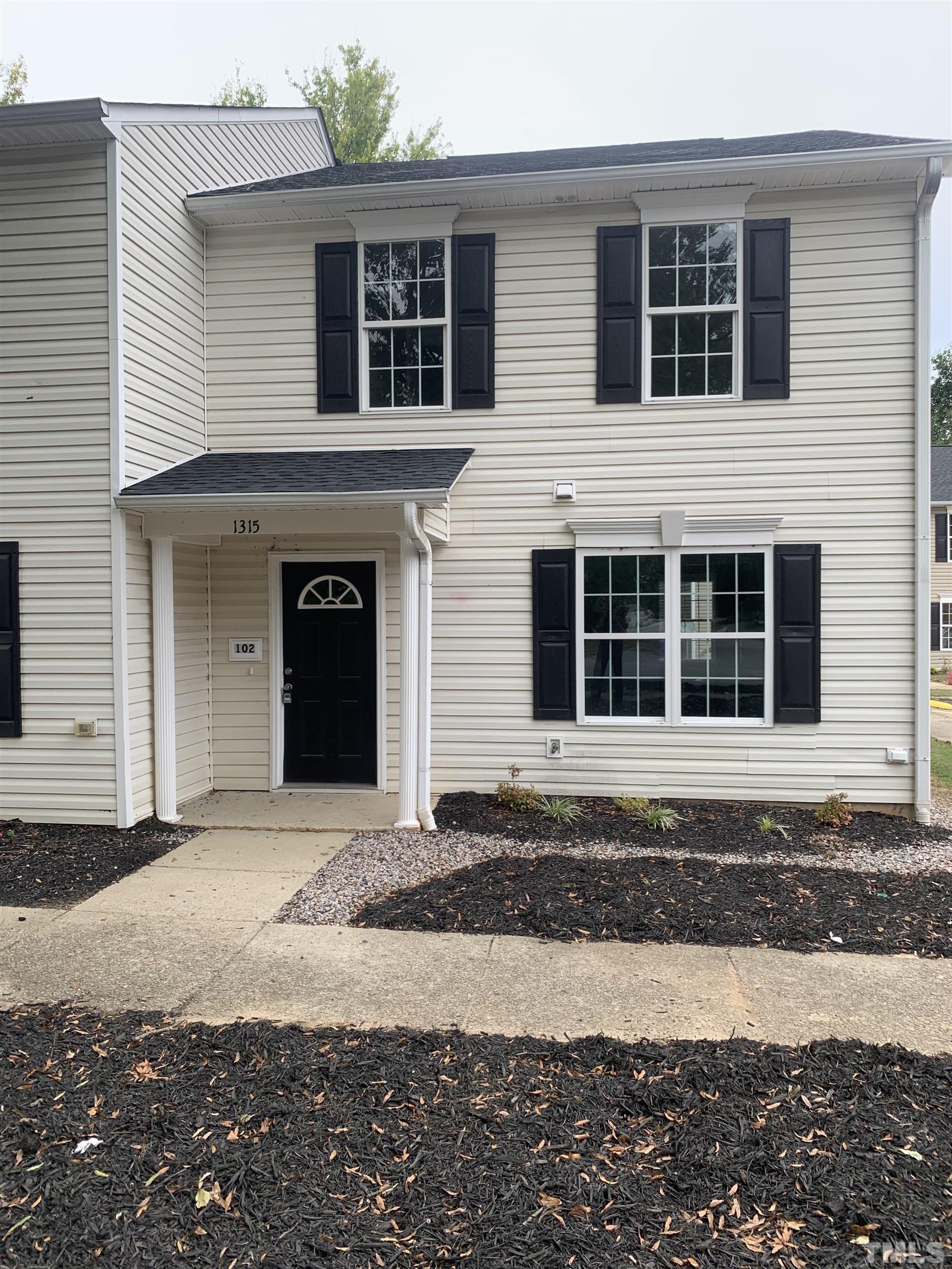 1315 East Lane Street, Unit 102 Raleigh, NC 27610 - Photo 1 of 6 a front view of a house