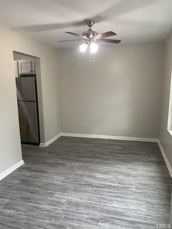 a view of a room with wooden floor