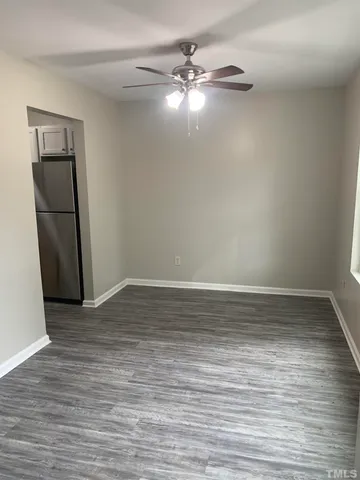 a view of a room with wooden floor