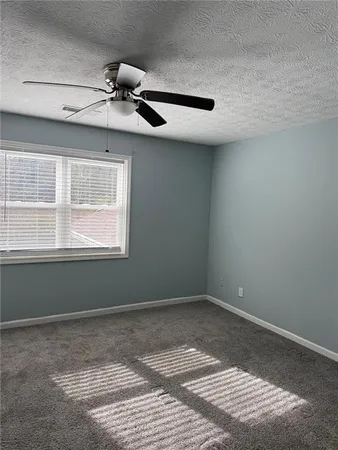 a view of a room with a window and a ceiling fan