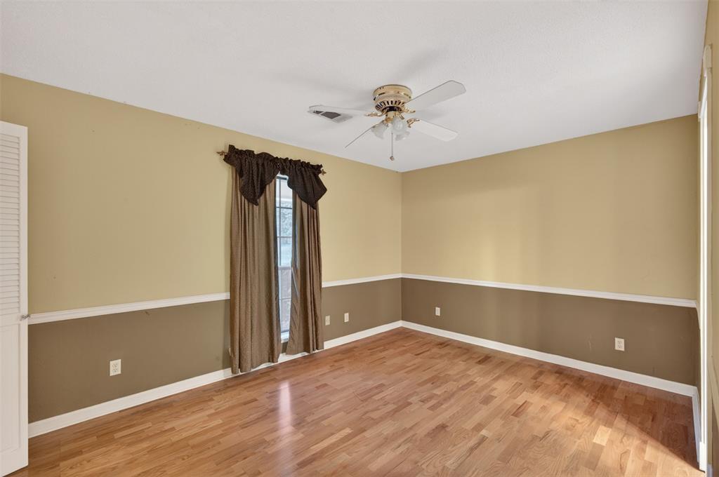 401 Cane Bend Drive Haughton, LA 71037 - Photo 17 of 27 a view of empty room with wooden floor and ceiling fan