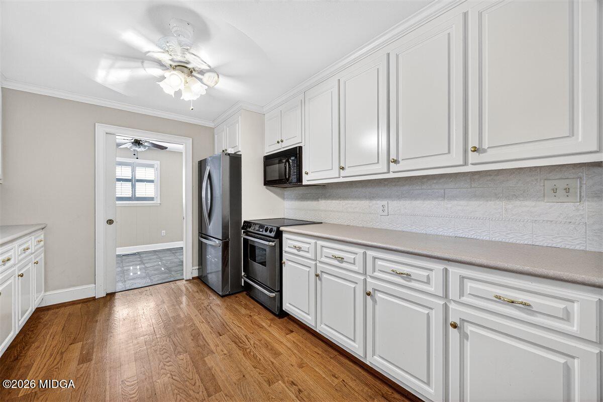 335 Hamrick Road Macon, GA 31220 - Photo 5 of 41 a kitchen with granite countertop white cabinets and stainless steel appliances