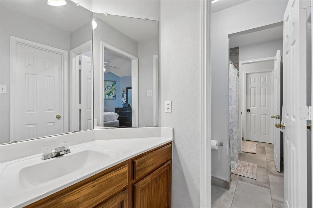 129 Timberbluff Lane Murphy, TX 75094 - Photo 31 of 34 a bathroom with a granite countertop sink and a mirror