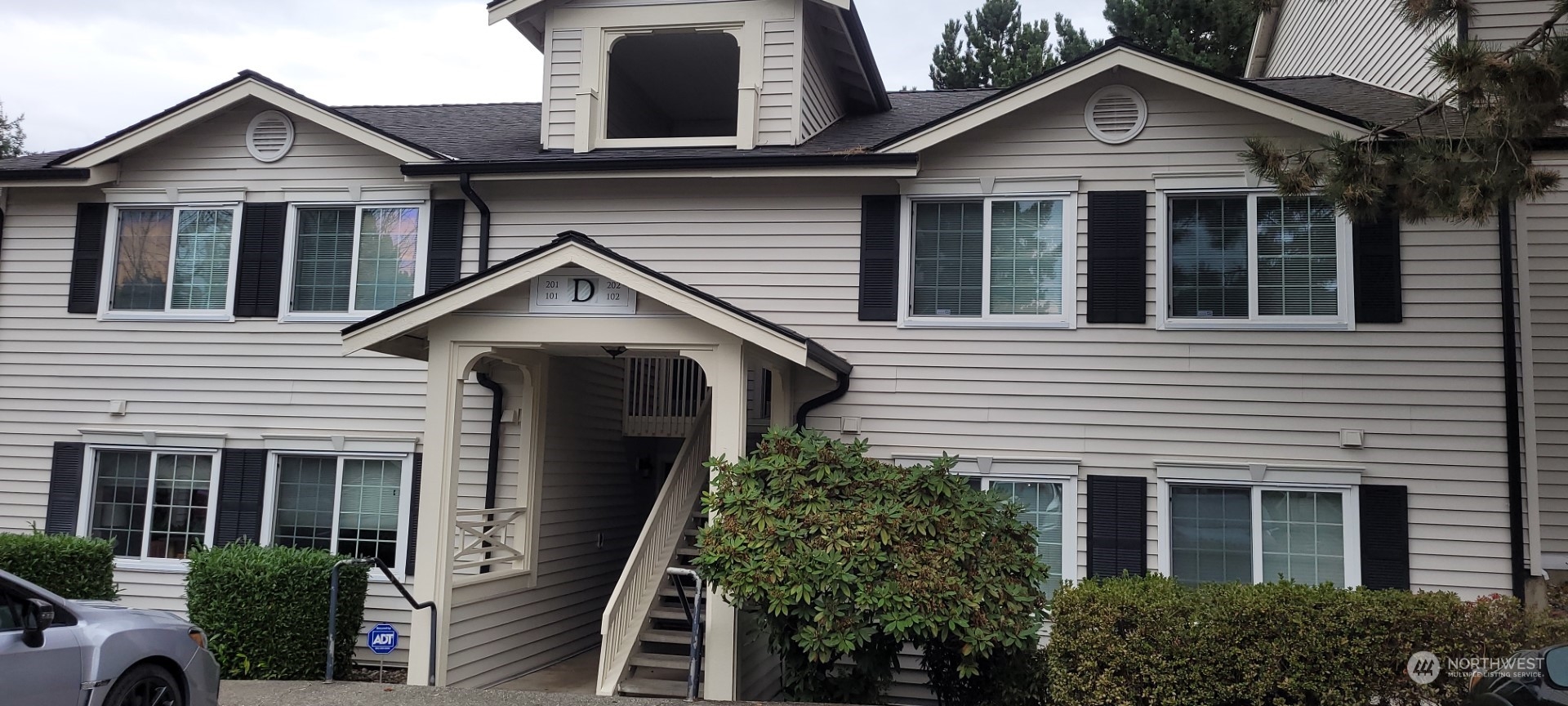 12404 East Gibson Road, Unit D201 Everett, WA 98204 - Photo 2 of 22 a view of a house with a yard and potted plants