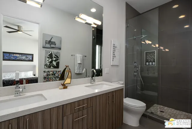 a bathroom with a double vanity sink toilet and shower