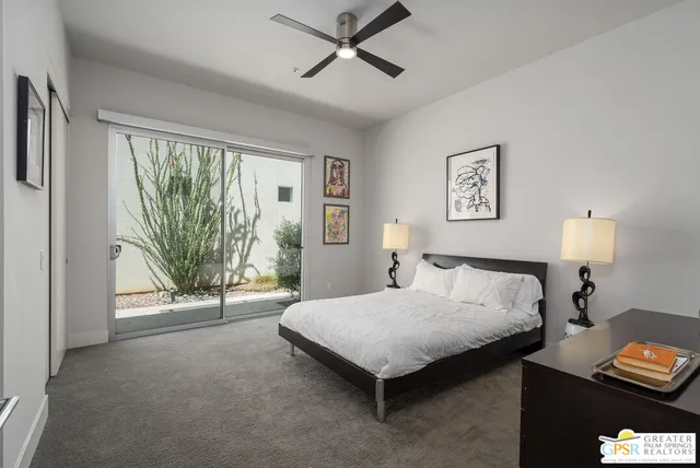 a spacious bedroom with a bed and a large window