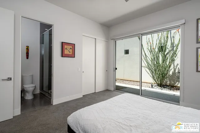 a bedroom with a bed and a large window