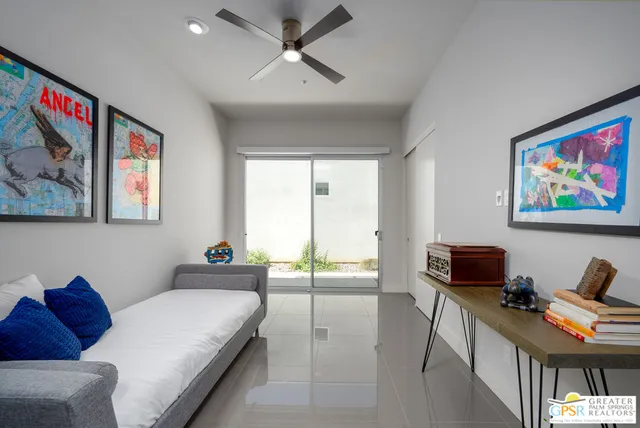 a bedroom with furniture and a flat screen tv