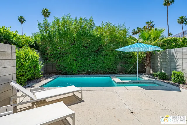 a view of backyard with plants and outdoor seating