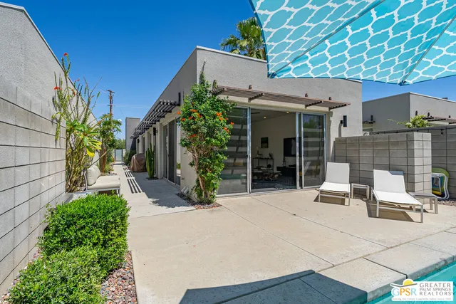 a view of a patio with table and chairs and potted plants