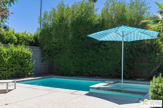 a view of a table and chairs in the garden