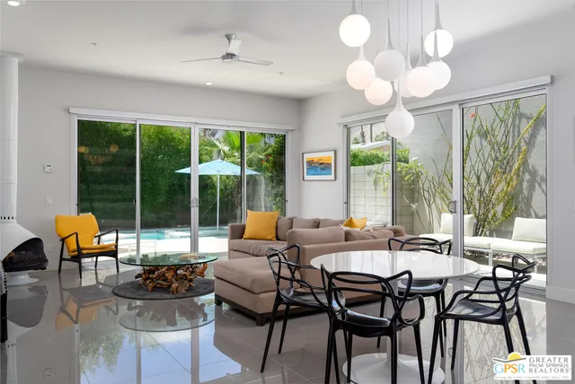 a view of a dining room with furniture large windows and wooden floor