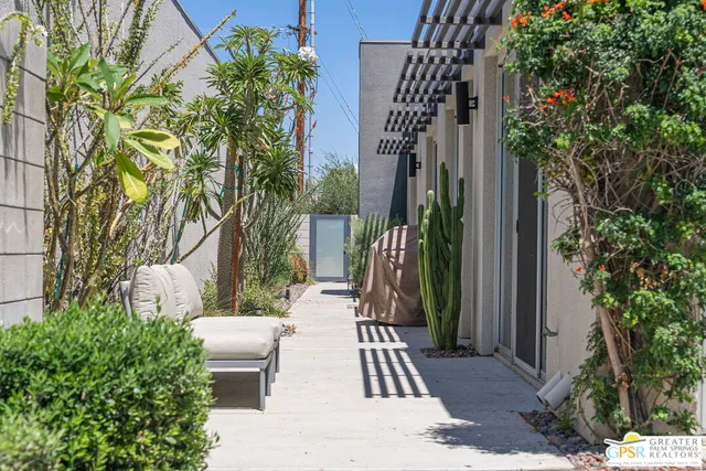 a view of balcony with chairs and potted plants