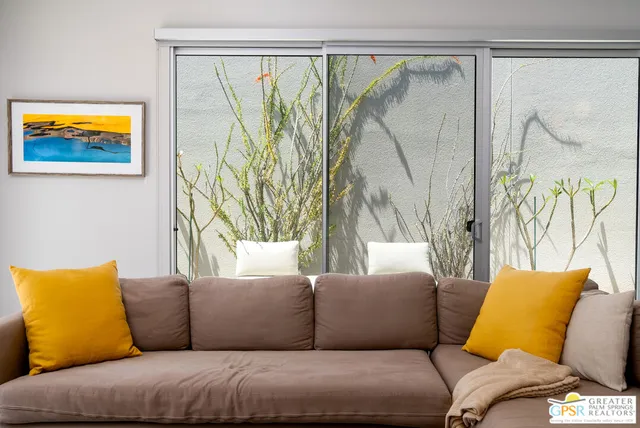 a living room with a couch and a large window