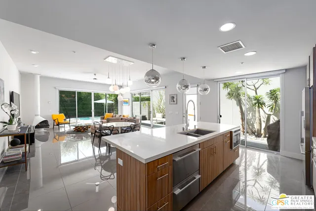 a view of a kitchen with kitchen island granite countertop a large window