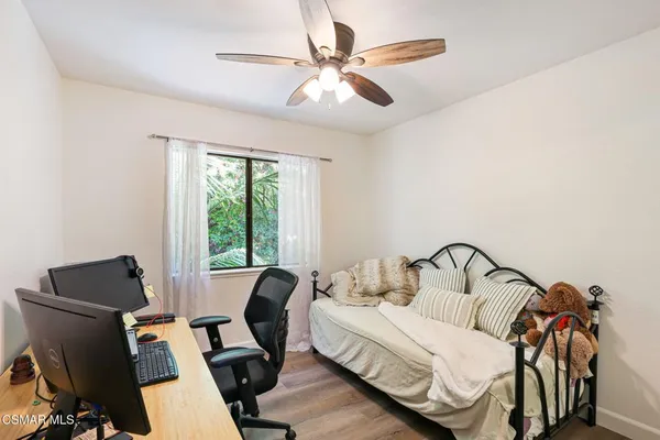 a bedroom with furniture and a window
