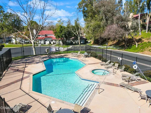 a view of a swimming pool with furniture