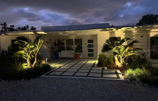 a view of a patio with table and chairs and potted plants