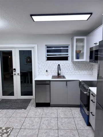 a kitchen with stainless steel appliances granite countertop a sink and cabinets