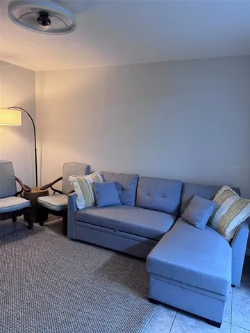 a living room with furniture and a lamp