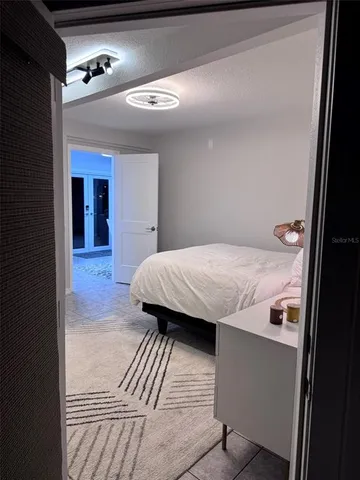 a en suite bathroom with a granite countertop sink and a mirror