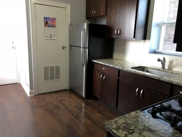 a kitchen with a sink refrigerator and microwave