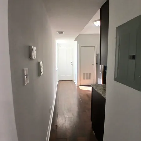 a view of hallway with wooden floor