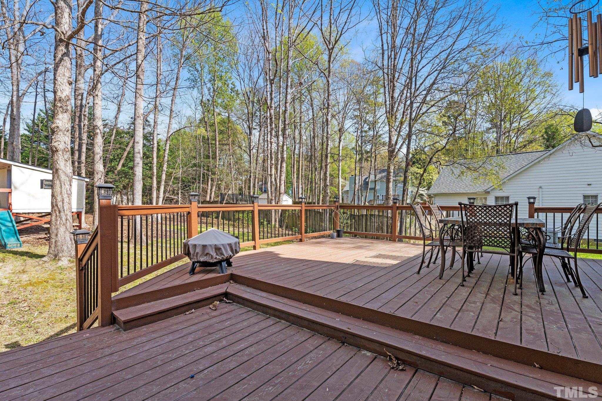 3408 Ribcowski Court Raleigh, NC 27616 - Photo 27 of 48 a view of a roof deck with table and chairs and wooden floor