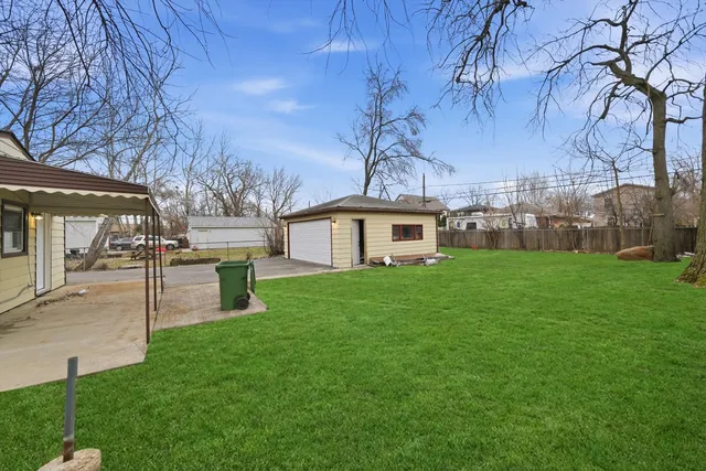 a view of an house with backyard space and sitting area