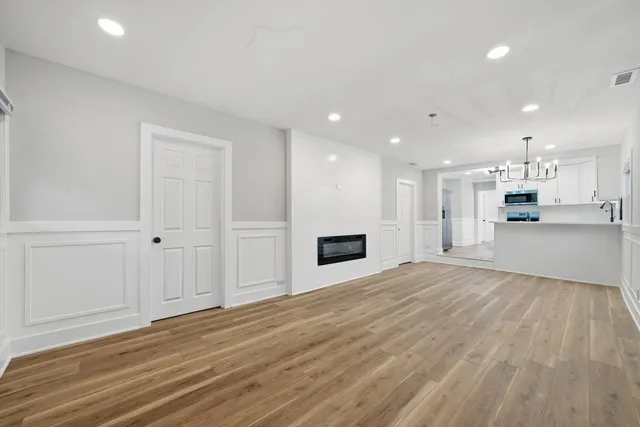 a view of a kitchen with a sink and a refrigerator