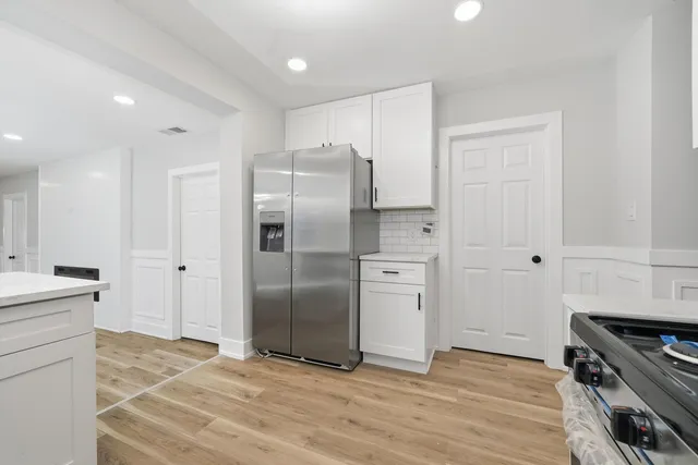a kitchen with stainless steel appliances a refrigerator sink and stove