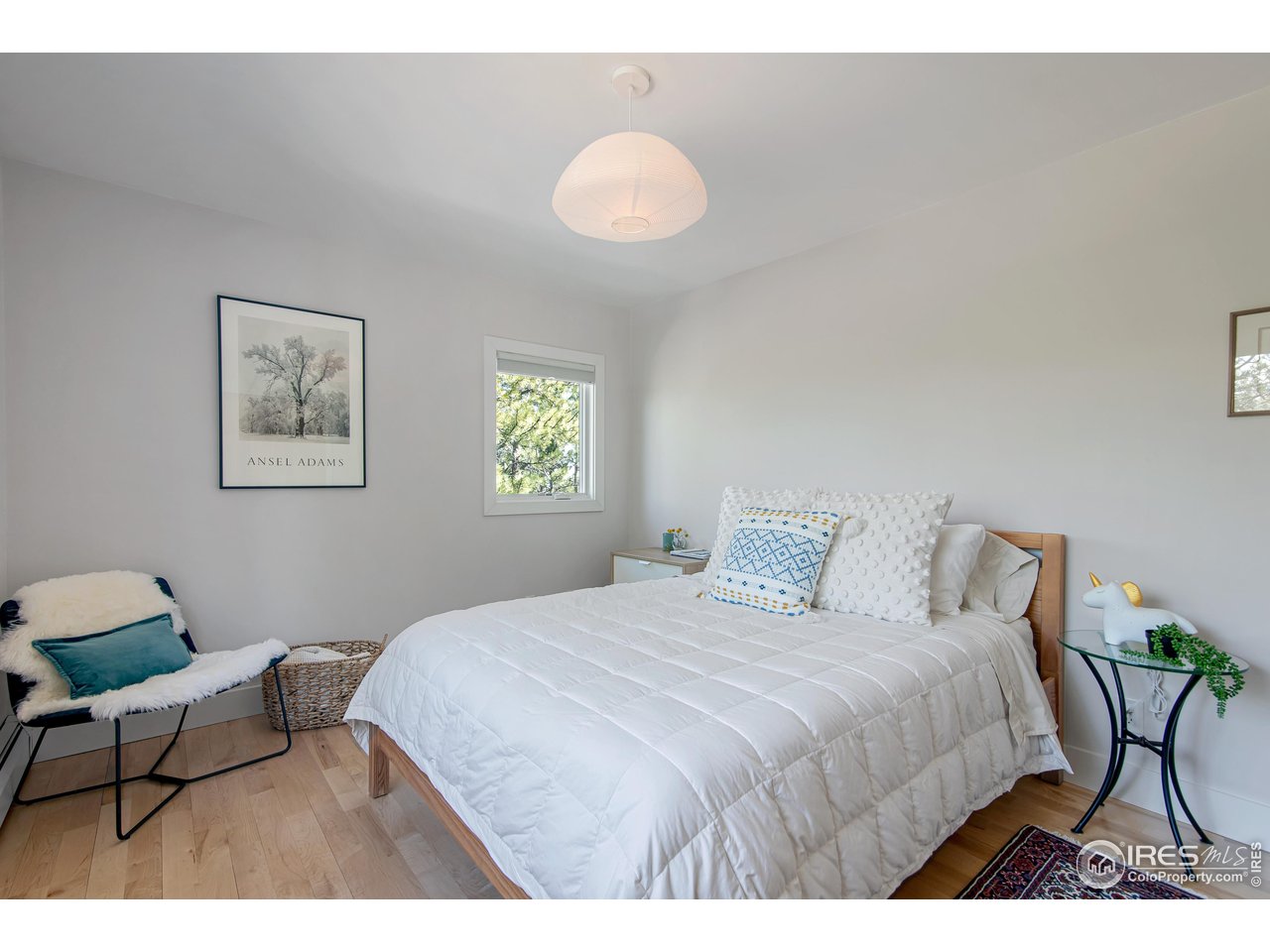 65 Bristlecone Way Boulder, CO 80304 - Photo 14 of 49 a bedroom with a bed and a chandelier