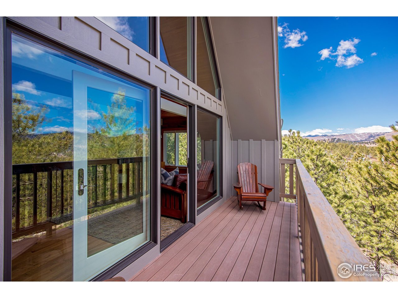 65 Bristlecone Way Boulder, CO 80304 - Photo 2 of 49 a view of a balcony dining area with furniture and wooden floor