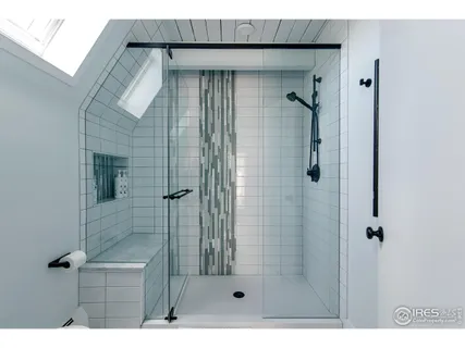 a bathroom with a granite countertop sink a large mirror a shower and a bathtub