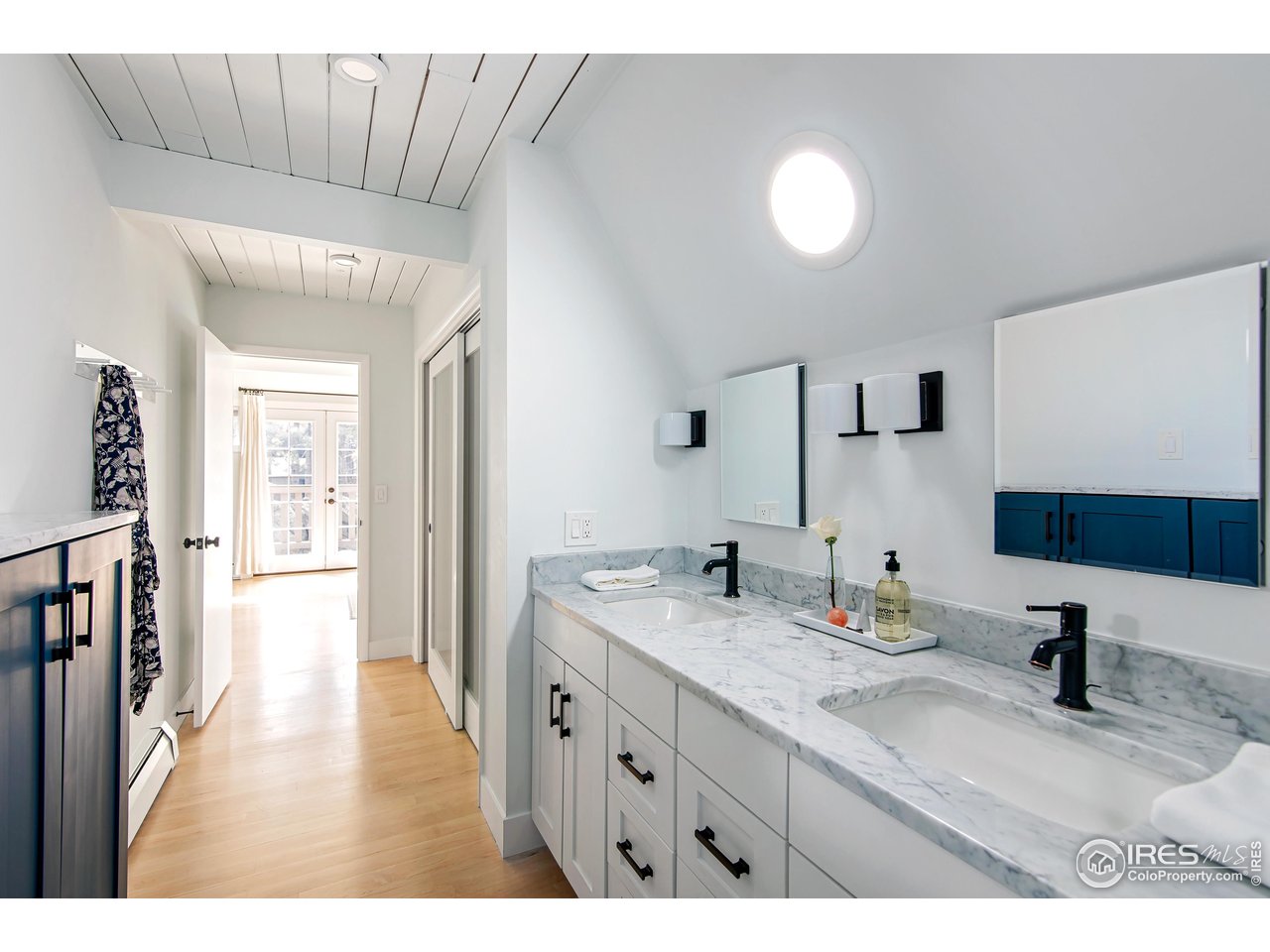 65 Bristlecone Way Boulder, CO 80304 - Photo 23 of 49 a bathroom with a sink a mirror and a toilet