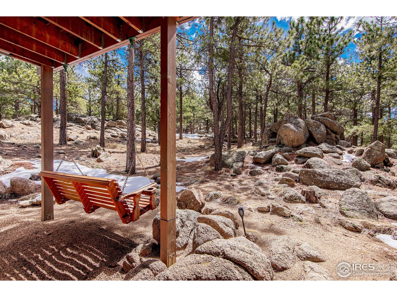 65 Bristlecone Way Boulder, CO 80304 - Photo 9 of 49 a bench sitting in the middle of a yard
