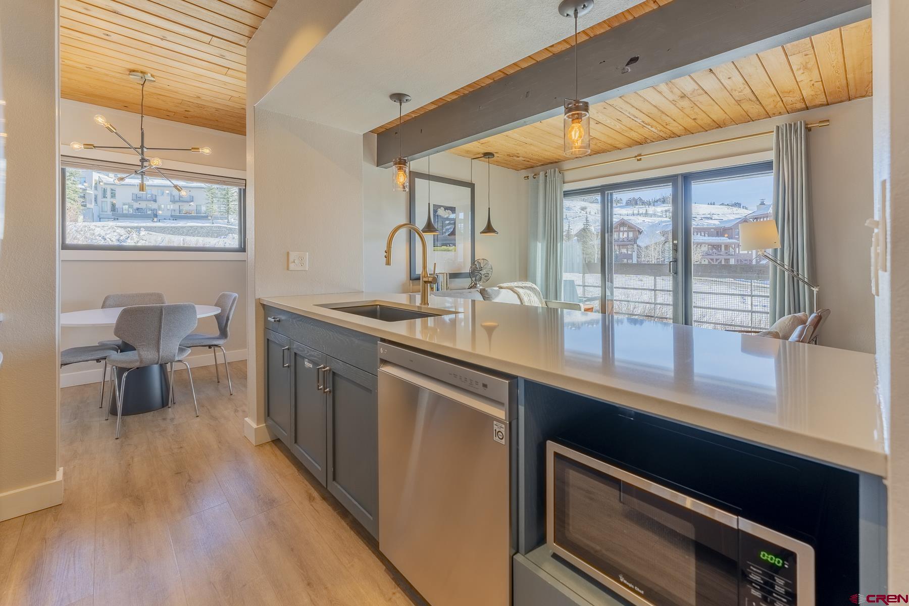 400 Gothic Road, Unit 207 Crested Butte, CO 81225 - Photo 11 of 35 a kitchen with sink cabinets and wooden floor