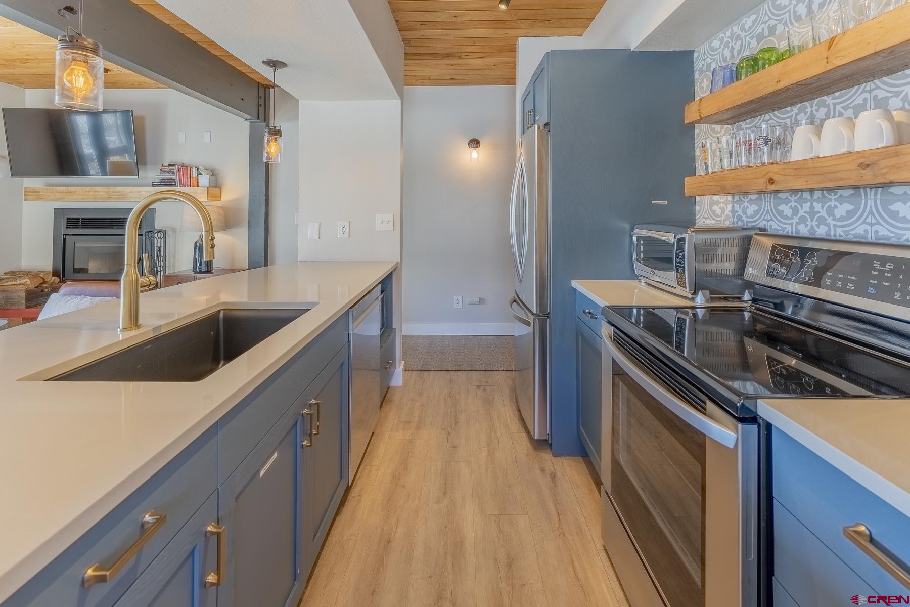 400 Gothic Road, Unit 207 Crested Butte, CO 81225 - Photo 12 of 35 a kitchen with stainless steel appliances granite countertop a sink and a stove