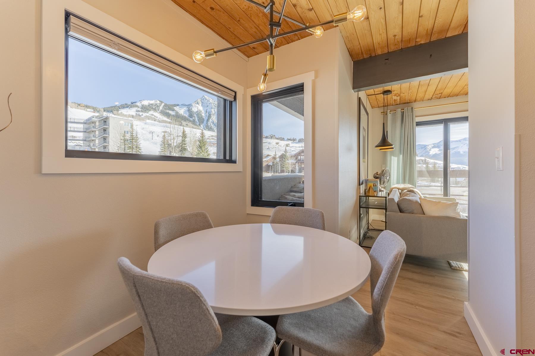 400 Gothic Road, Unit 207 Crested Butte, CO 81225 - Photo 13 of 35 a view of a dining room with furniture wooden floor and a chandelier