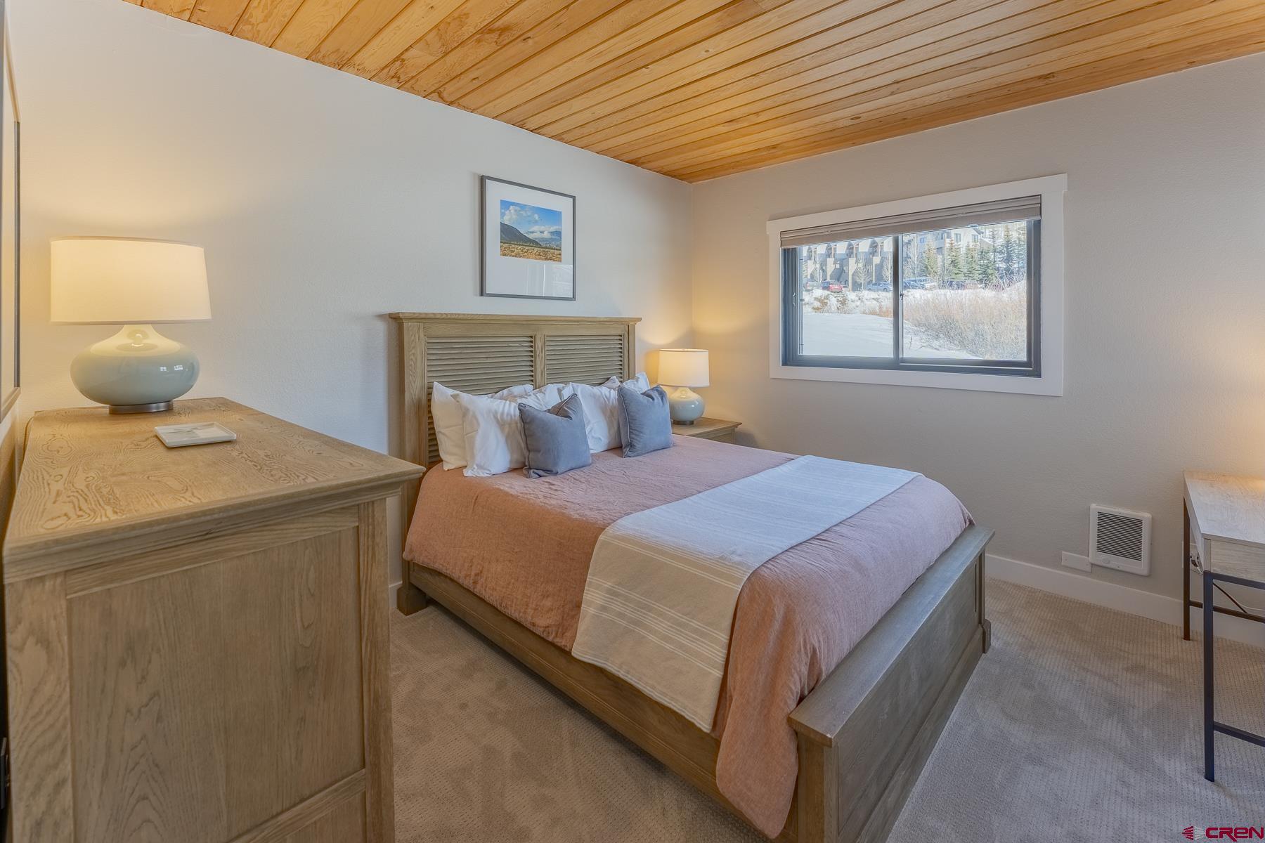400 Gothic Road, Unit 207 Crested Butte, CO 81225 - Photo 14 of 35 a bedroom with a bed and window