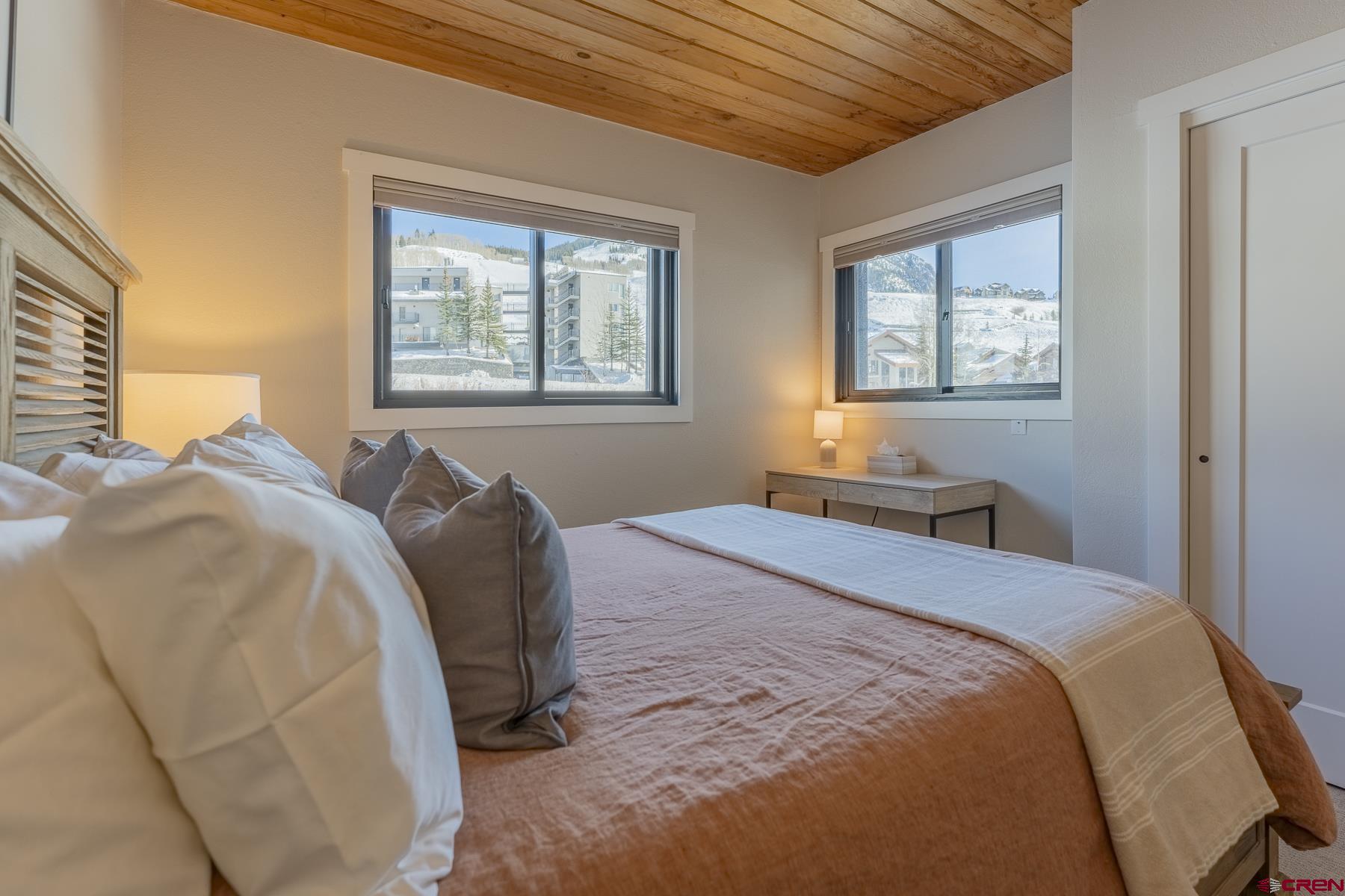 400 Gothic Road, Unit 207 Crested Butte, CO 81225 - Photo 15 of 35 a bedroom with a bed and a window