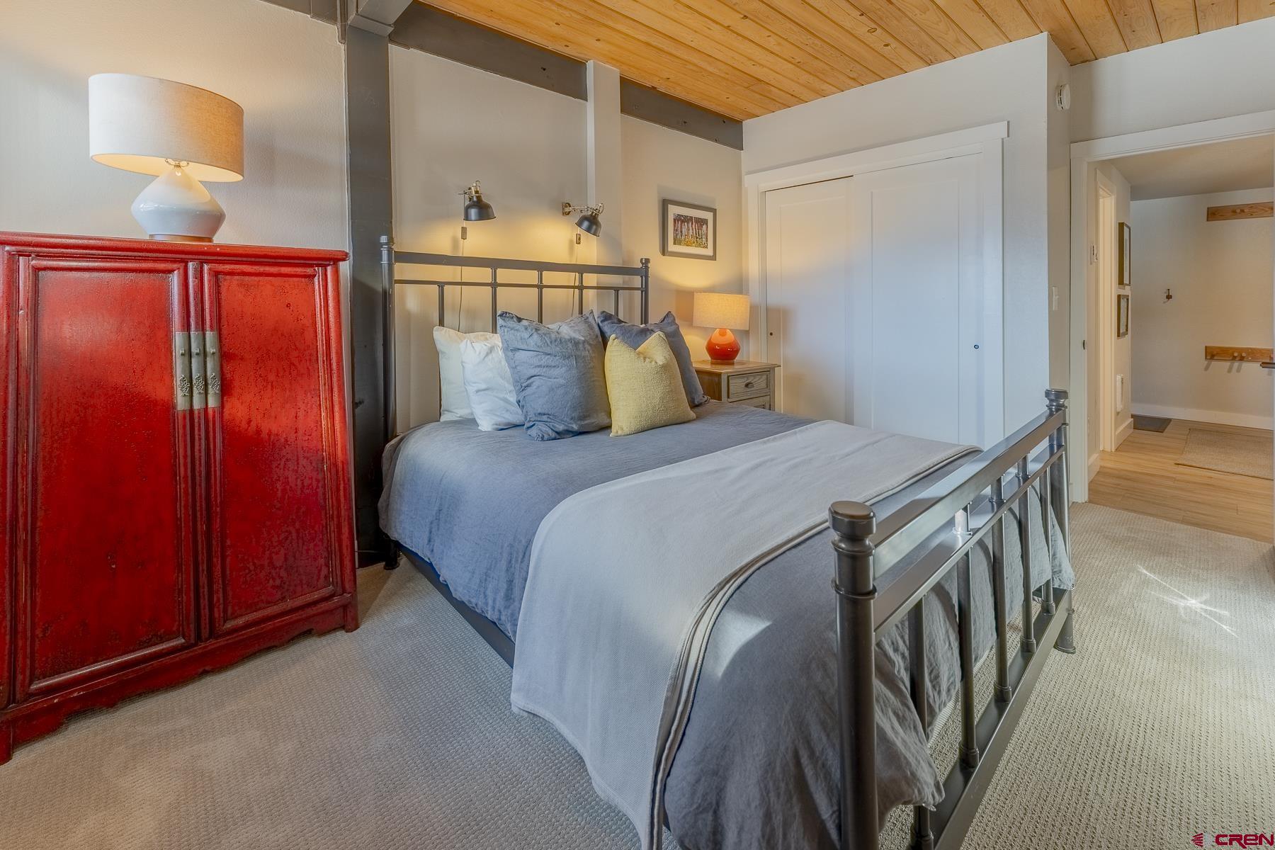 400 Gothic Road, Unit 207 Crested Butte, CO 81225 - Photo 21 of 35 a bedroom with a bed and a table