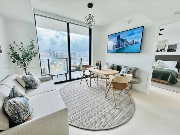 a living room with furniture and a large window